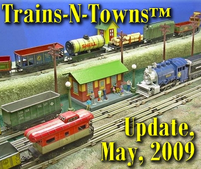 The official e-newsletter of Big Indoor Trains<sup><small>TM</small></sup> and Big Christmas Trains<sup><small>TM</small></sup>. This is a photo of some of Howard Lamey's tinplate train collection and some of his recent projects.  The tanker, lumber car, and green boxcar are home-made, as are the watchman's shanty and the tinplate-looking station.  The station is described in a new article this month.