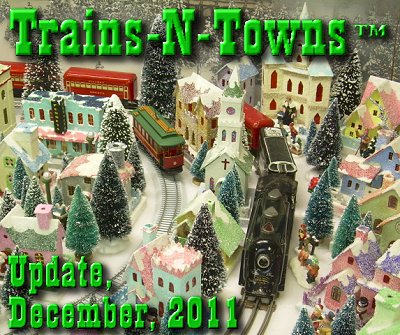 The official e-newsletter of Big Indoor Trains<sup><small>TM</small></sup> and Big Christmas Trains<sup><small>TM</small></sup>. This is a photo of Howard' Lamey's Christmas village pieces, including structures he built, an On30 Dept. 56 trolley, and a Marx Tinplate train. Howard is now a regular contributor on the CardboardChristmas.com forums.